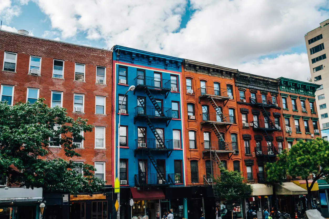 Beautiful cityscape of vintage colourful building with fire escape from residential flats and commercial real estate on ground floor