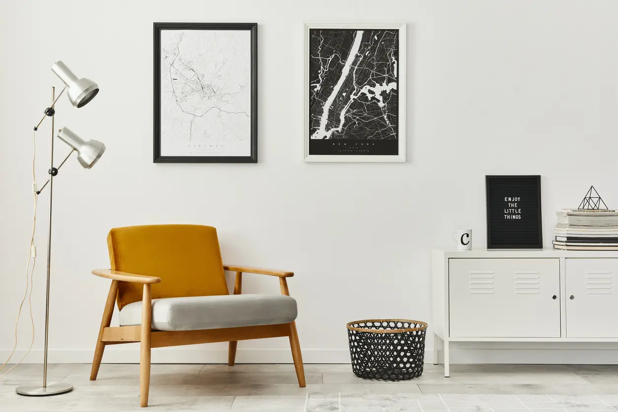 A stylish room with art on a white wall.