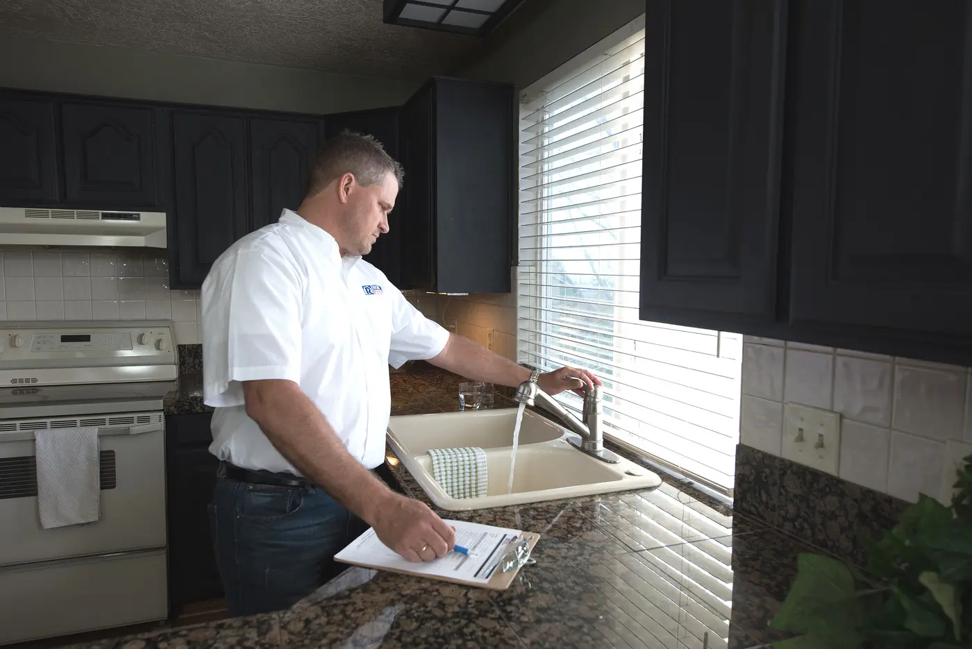 Real Property Management Gold staff inspecting the sink