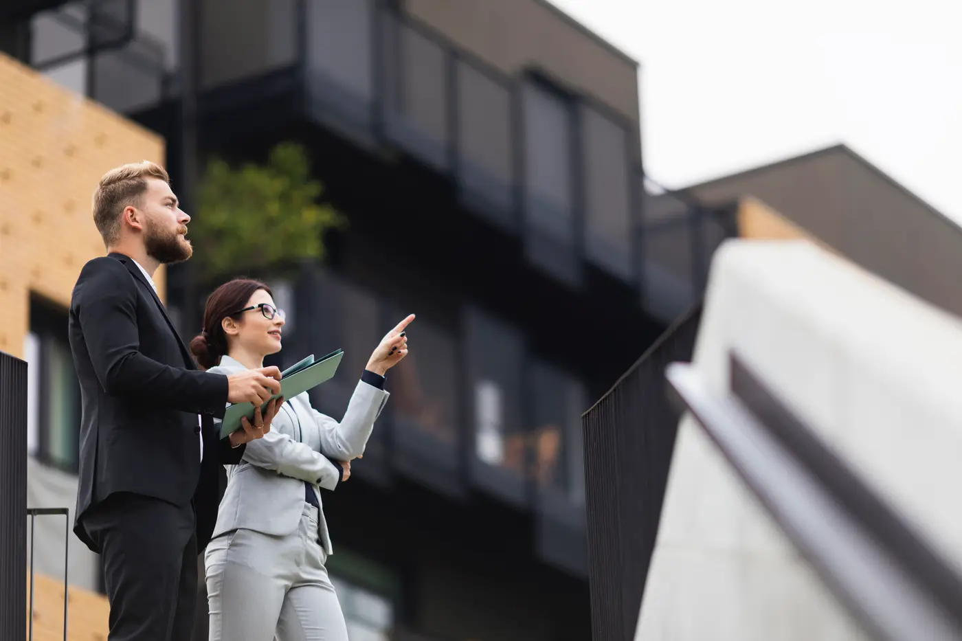 a woman looking at properties with a real estate agent