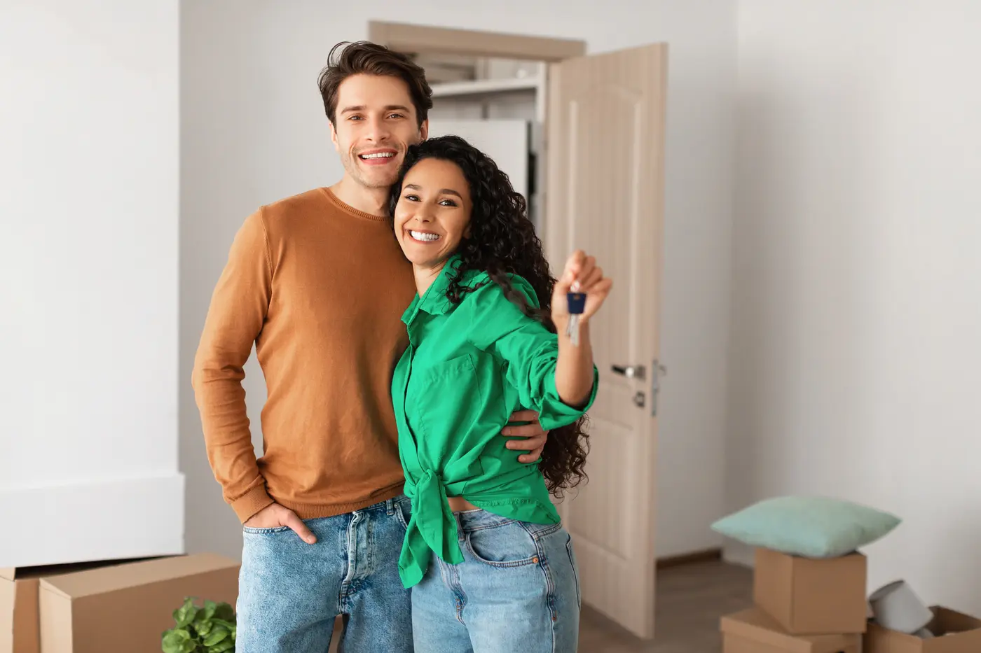 Happy couple showing keys at their rental home