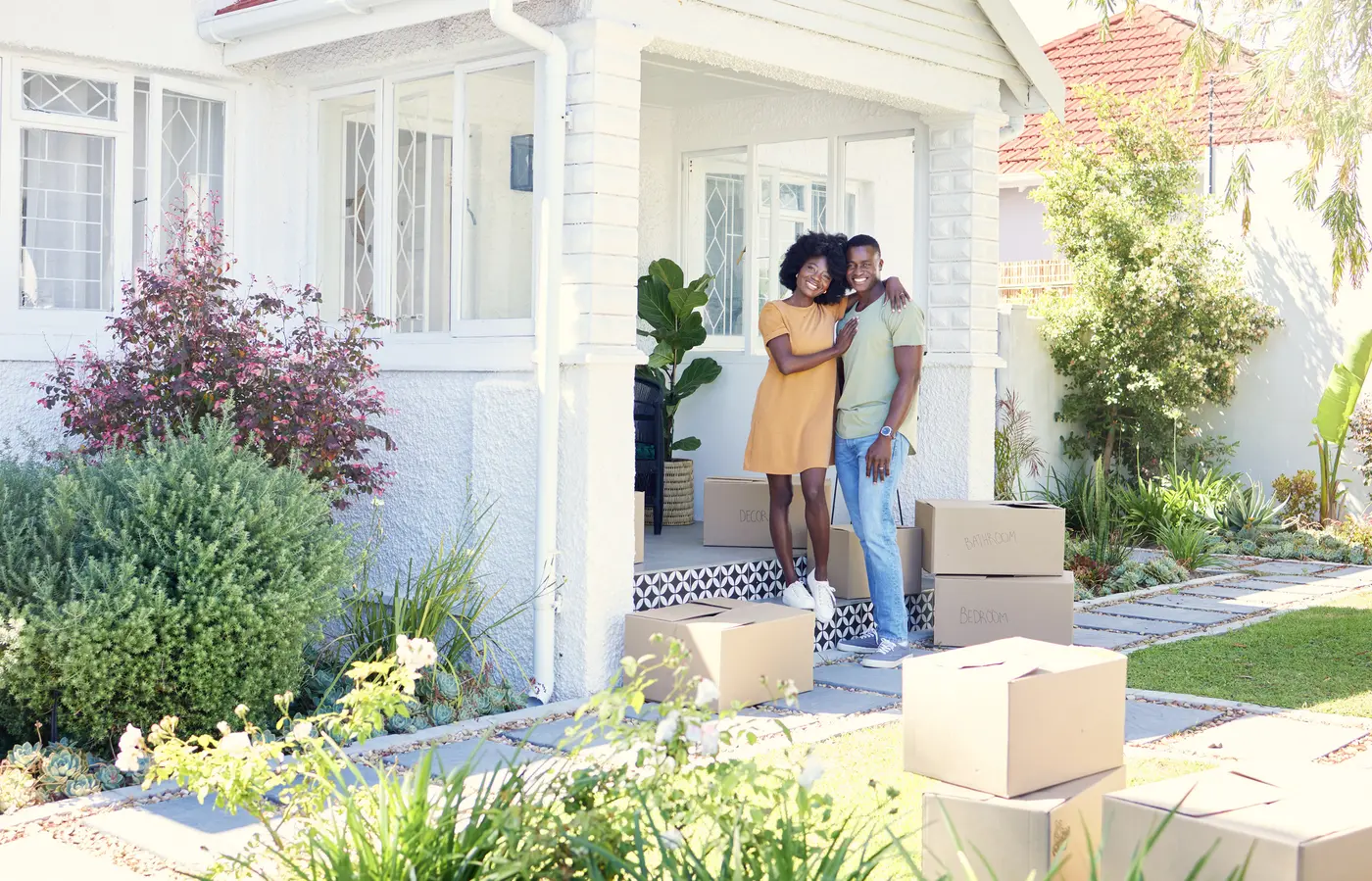Shot of a young couple moving into their new house