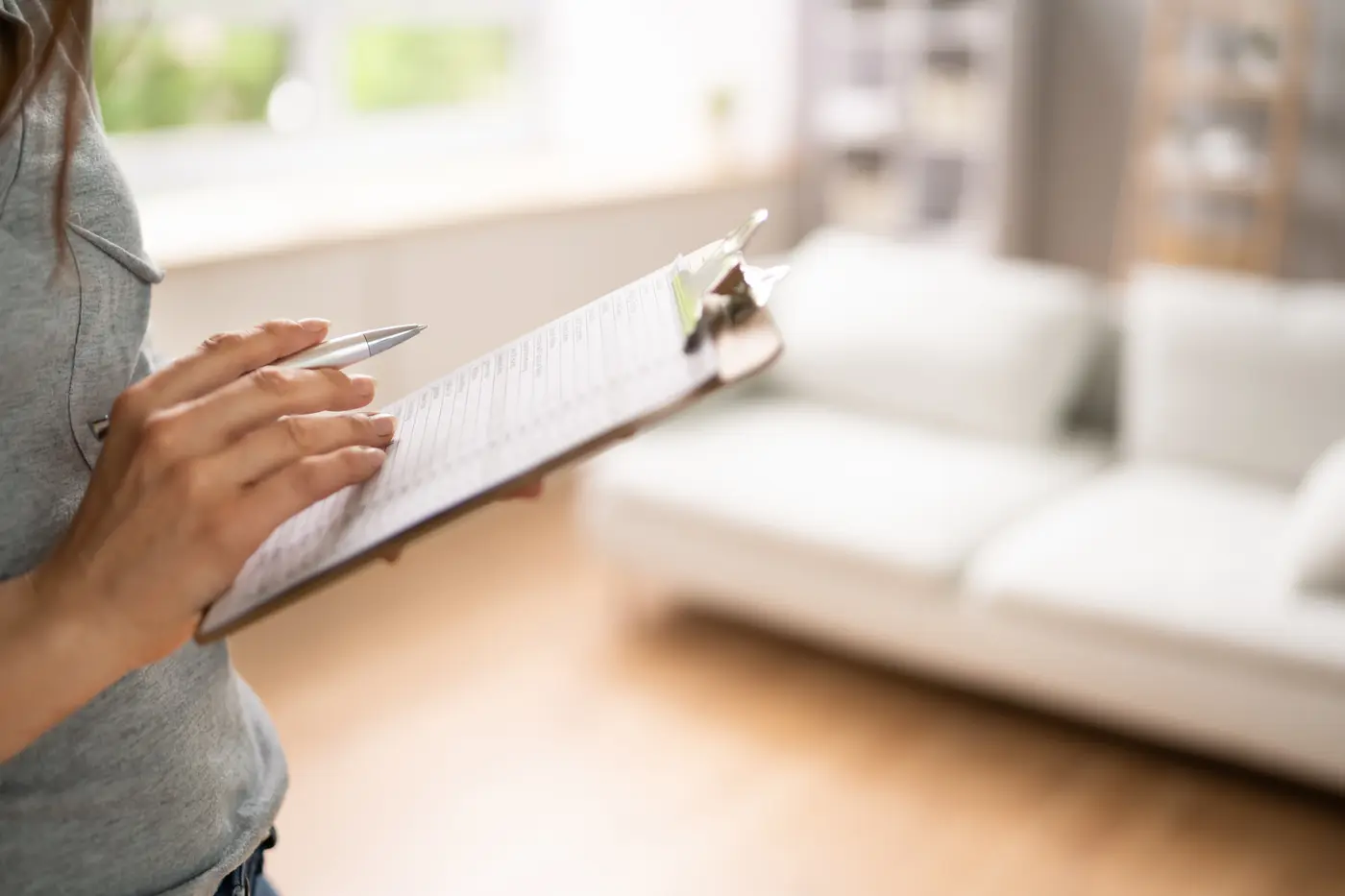 Woman Filling Rental Property Evaluation Form