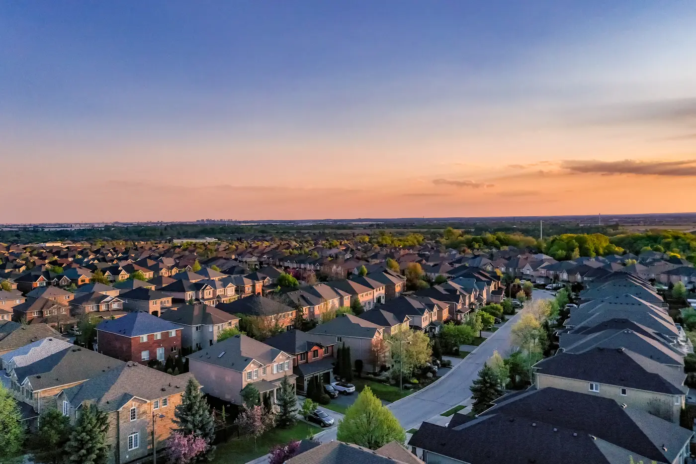 Aerial view of residential neighborhood, detached and duplex houses.