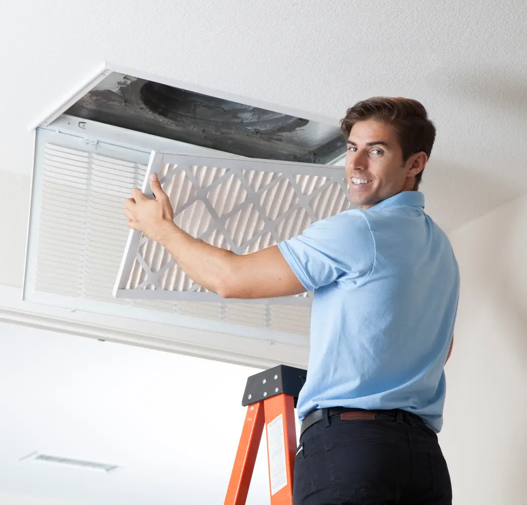 Maintenance Man Installing a Fresh Air Filter in the HVAC System