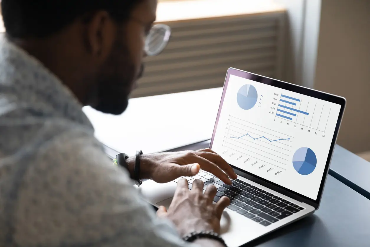 Waldorf Real Estate Investor Reviewing Data on a Laptop