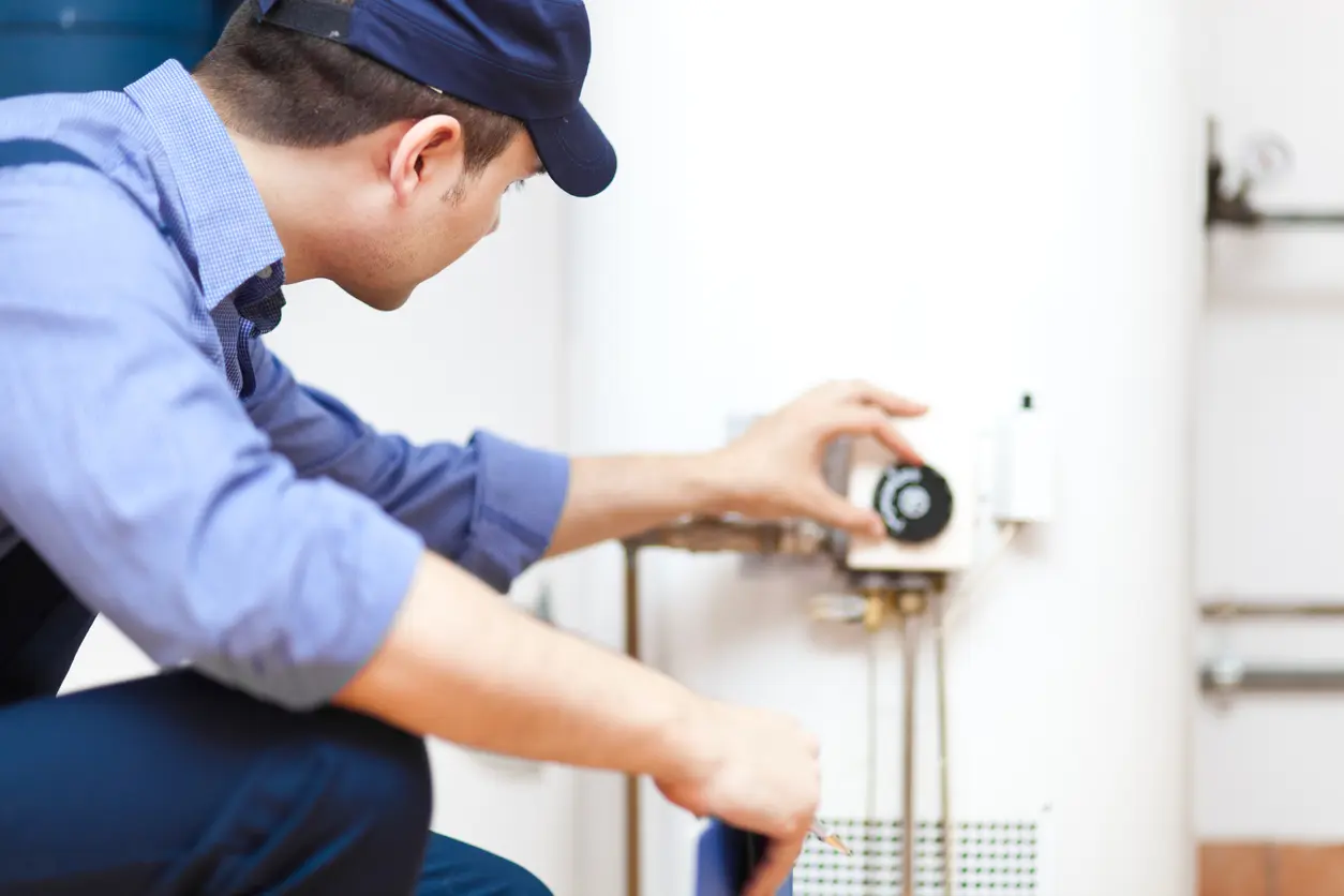 Man Fixing a Water Heater in Southern Maryland Rental Property