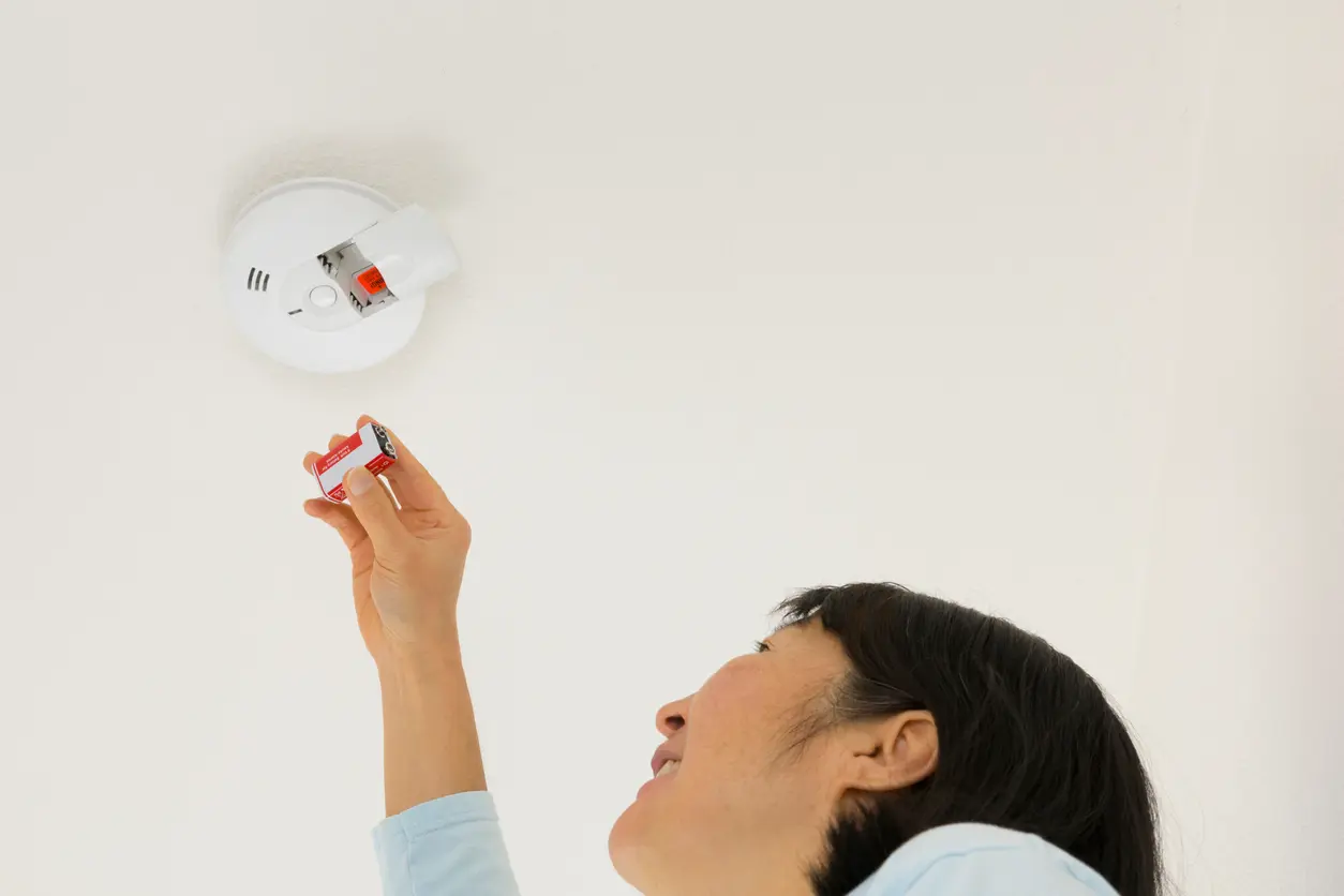 White Plains Tenant Replacing a Battery in the Smoke Detector