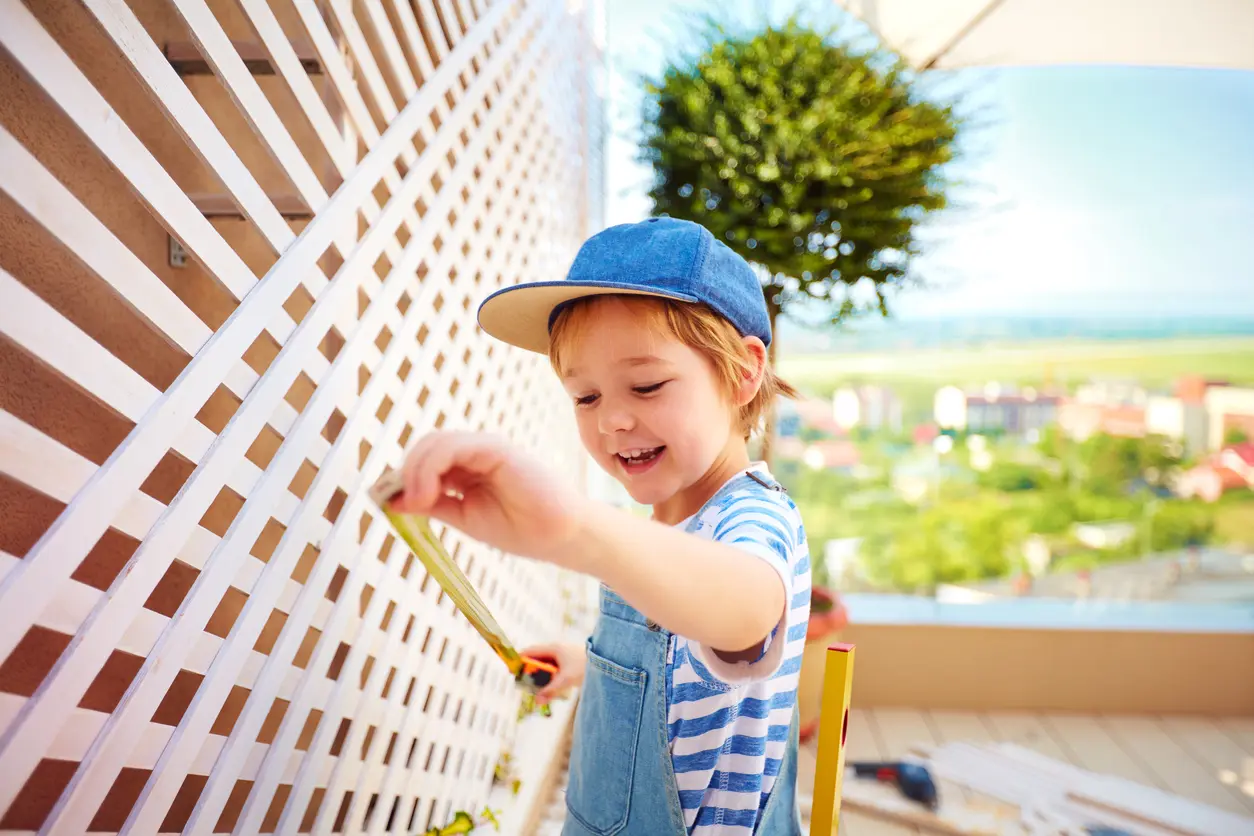 Young Upper Marlboro Resident Measuring the Trellis on an Outdoor Patio